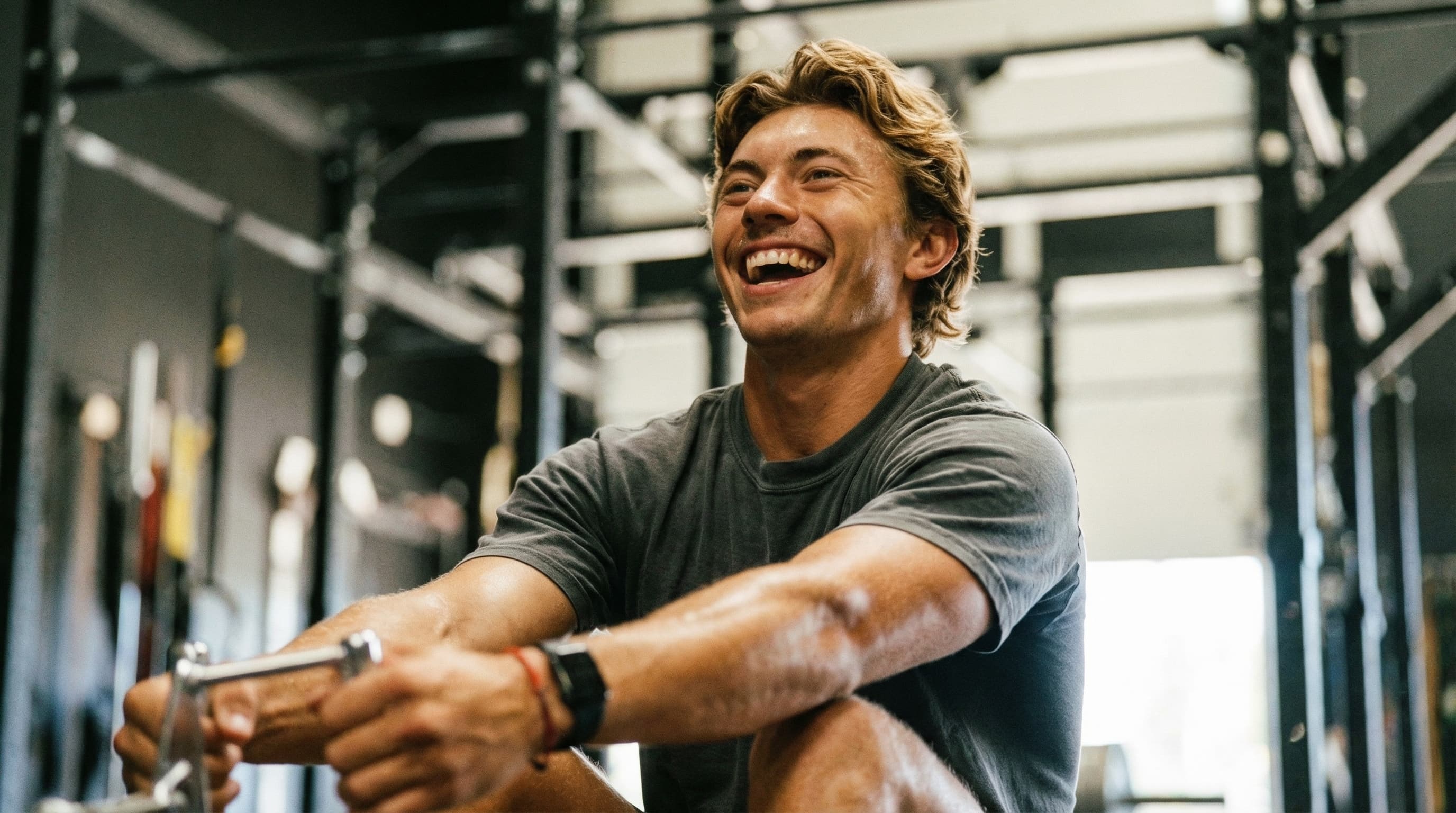 Man in his late 40s laughing in the gym, healthy and capable