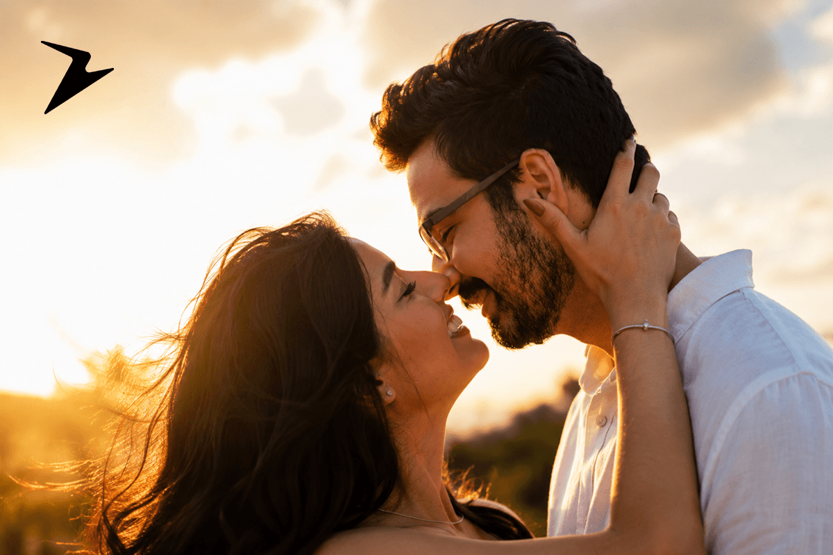 Couple sharing a romantic embrace at sunset outdoors